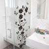 A glass shower door features a black flower and butterfly vine wall sticker design.