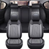 Black full coverage PU leather car seat covers shown in a vehicle interior.