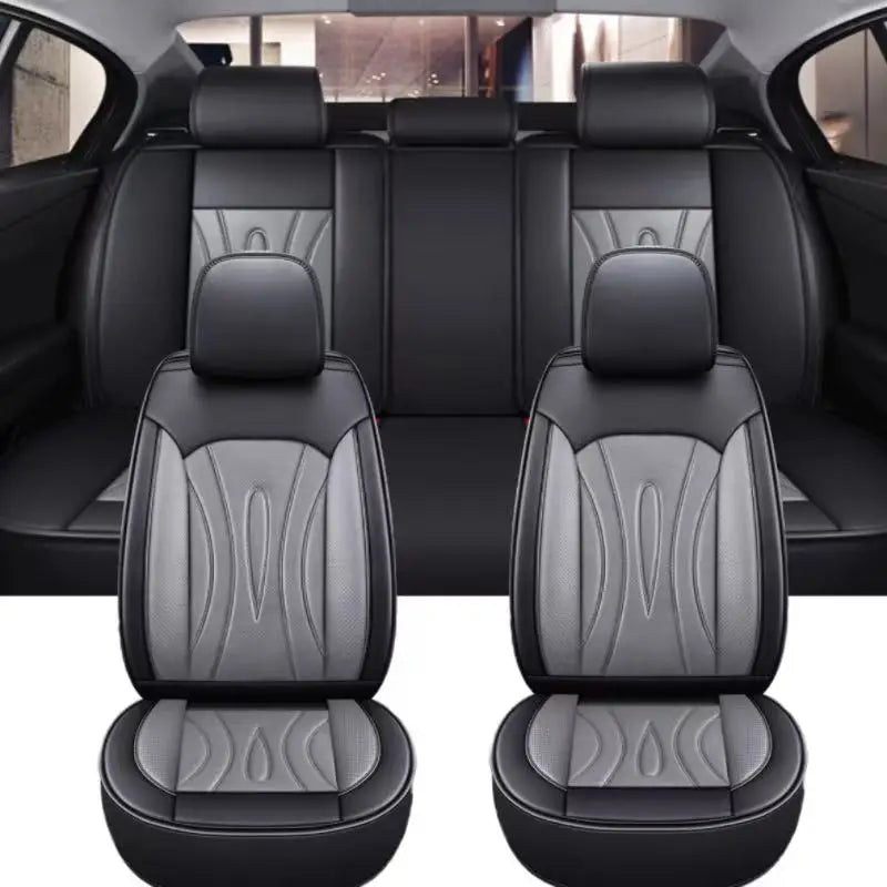 Black full coverage PU leather car seat covers shown in a vehicle interior.