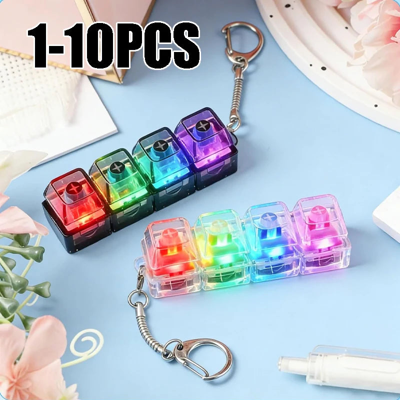A set of 10 LED clickable fidget keychains with a keyboard design displayed on a blue background.