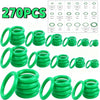 A collection of green automotive air conditioning O-ring gaskets and seals in various sizes and configurations.