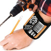 A hand holds a magnetic wrist strap with various screws and nails attached for tool storage.