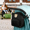 A black embroidered bear stroller organizer bag is shown resting on a light blue fabric.