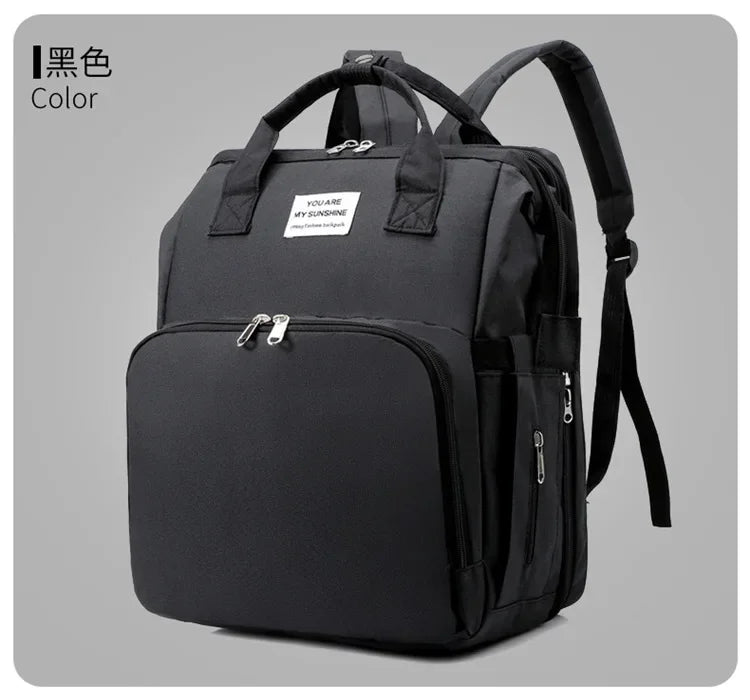 Black large capacity diaper bag backpack with a front pocket and changing mat feature