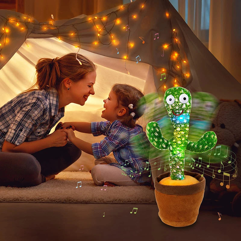 A happy mother and child interacting with a glowing dancing cactus plush toy decorated with string lights.