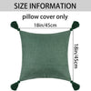 A square olive green linen pillow cover with tassels shown flat.