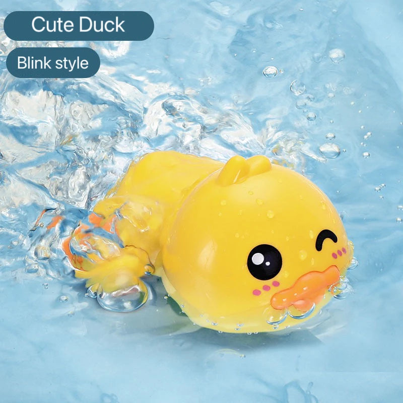 A yellow cute duck bath toy with a blink style face is floating in clear water.