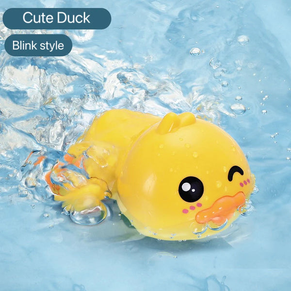A yellow cute duck bath toy with a blink style face is floating in clear water.