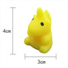 A bright yellow, squishy dinosaur-shaped stress relief toy.