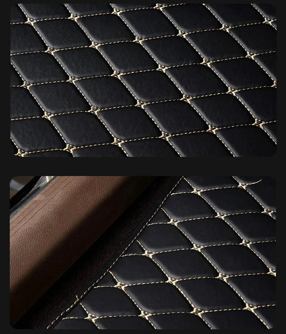 Close-up view of black quilted PU leather car floor mats with gold stitching.