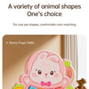 A pink bunny finger piano toy with colorful animal shapes and a bow, shown on a light surface.