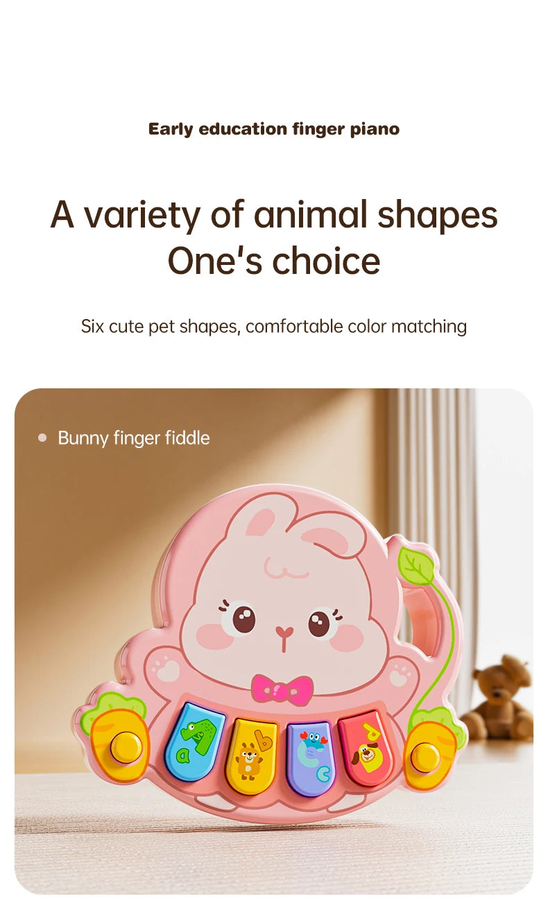 A pink bunny finger piano toy with colorful animal shapes and a bow, shown on a light surface.