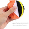 A hand holds a set of orange and black polishing pads with adhesive backing for car detailing.
