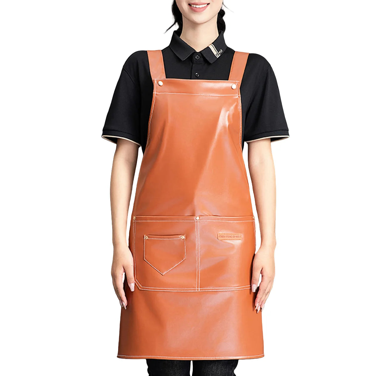 A woman wearing a tan PU leather multi-pocket kitchen apron over a black shirt.