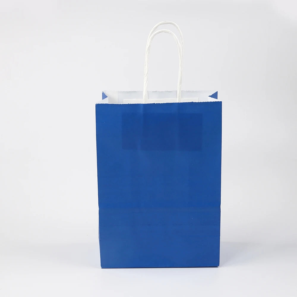 A blue paper gift bag with white handles against a white background.