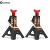 A pair of black metal jack stands with red lifting posts used for heavy-duty lifts on RC cars.