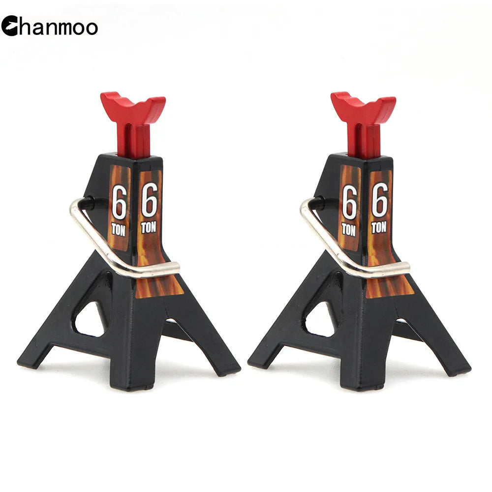 A pair of black metal jack stands with red lifting posts used for heavy-duty lifts on RC cars.