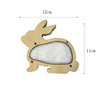 A wooden bunny shape with a felt interior, used as a Montessori busy board part for fine motor skills.