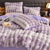 A fluffy lavender and white quilted bedding set featuring pillows and a duvet on a bed.