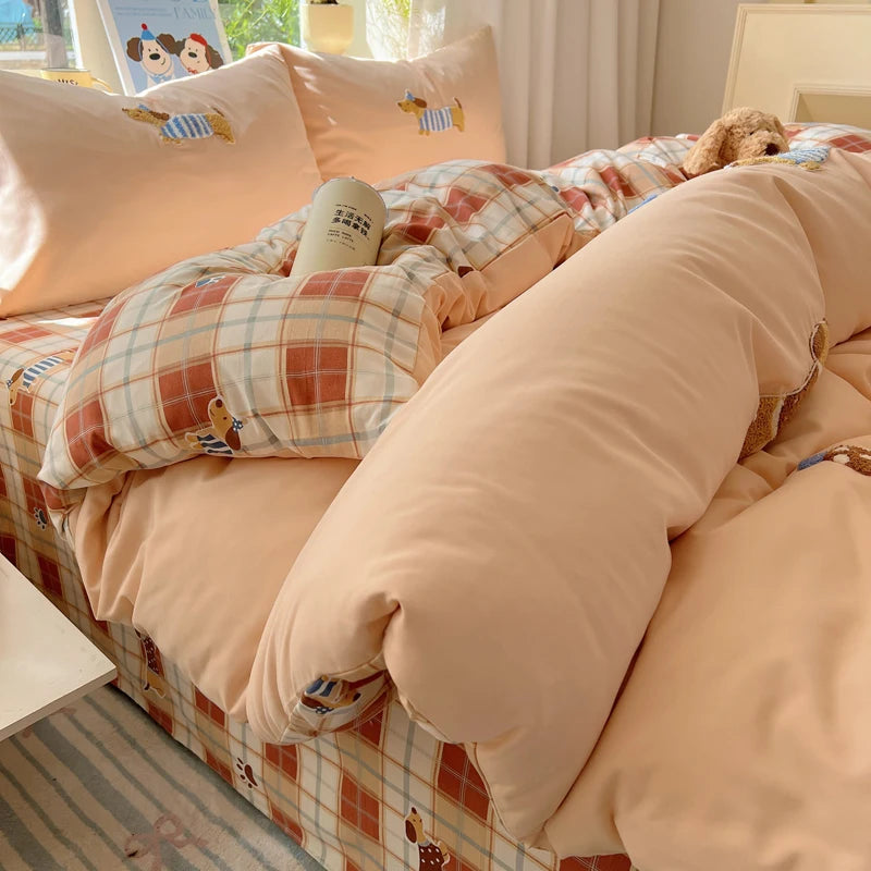 A beige cartoon embroidered duvet cover set with plaid accents and a fluffy teddy bear decoration.
