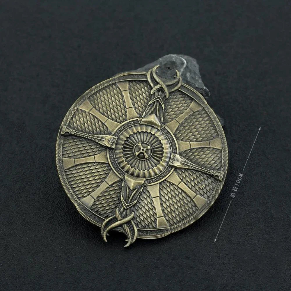 A round, intricately patterned metal ornament resembling a sword, set against a dark background.
