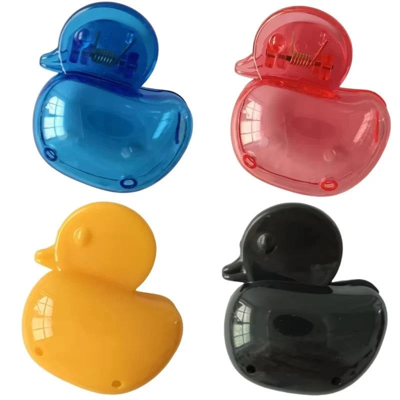 Four silicone toothbrush head covers in blue, pink, yellow, and black with clips.