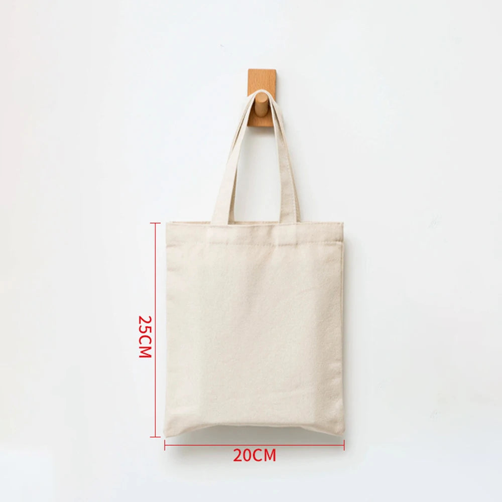 A beige canvas shopping tote bag with a wooden handle, shown against a white background.