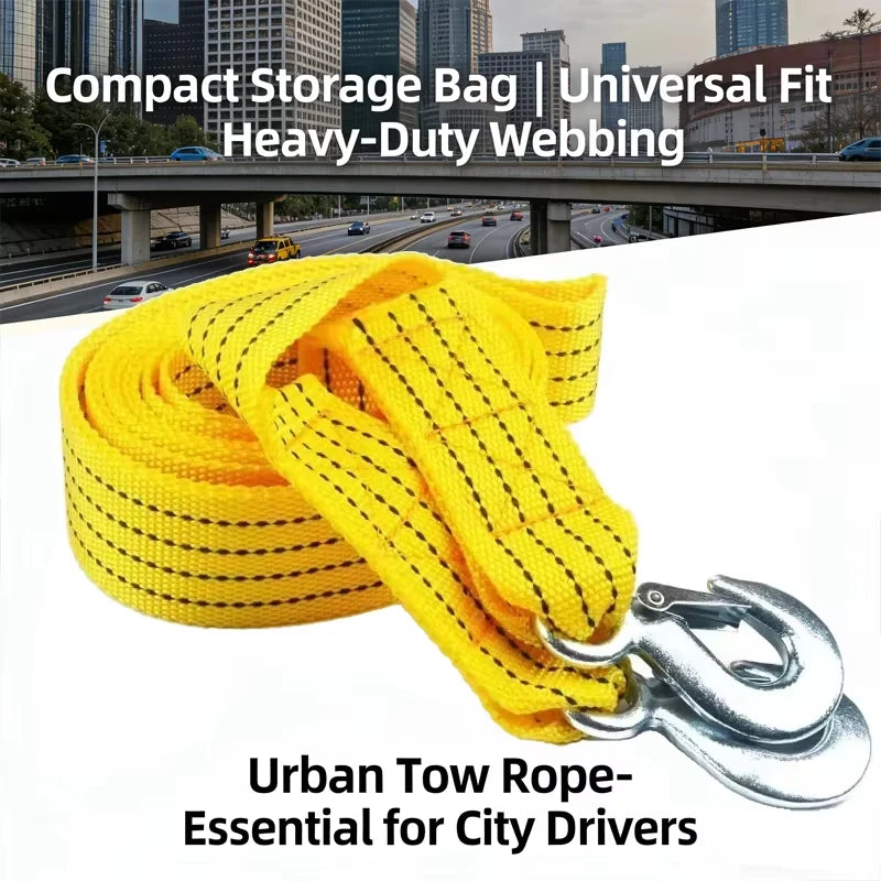 Yellow heavy-duty webbing tow rope with metal hooks shown against an urban cityscape background.