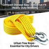 Yellow heavy-duty webbing tow rope with metal hooks shown against an urban cityscape background.