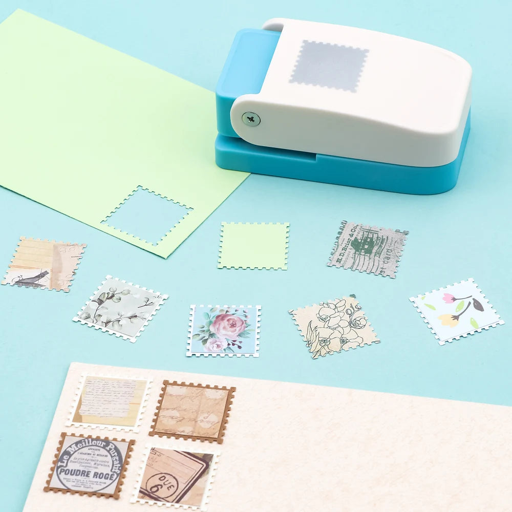 A white and blue square postage stamp paper punch is shown with various decorative stamps on a light blue background.