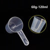 Clear plastic measuring cup with a long spout and graduated markings, shown against a black background.