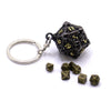 A black, hollow box-style die with a silver ring attached, alongside several loose dice.