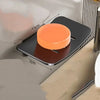 An aluminum wall-mounted soap dish with a drain, featuring an orange soap holder and a brown base.