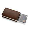 A brown leather card holder with a sliding sleeve displaying several credit cards.