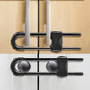 Close-up of adjustable U-shaped cabinet locks with knob handles installed on a light wood cabinet door.