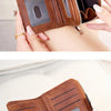 A brown leather wallet with a zipper closure and RFID blocking features is shown being held by a hand.