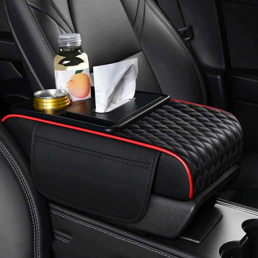 Black car armrest cushion with storage and cup holders featuring a quilted texture and red stitching