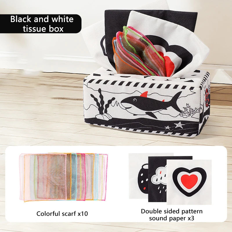 Black and white tissue box with colorful scarves and sound paper for sensory play