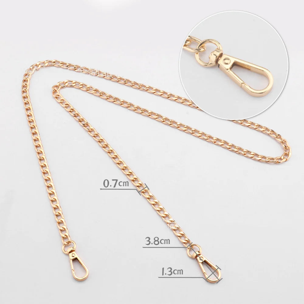 Gold-toned metal purse chain with adjustable buckles shown against a white background.