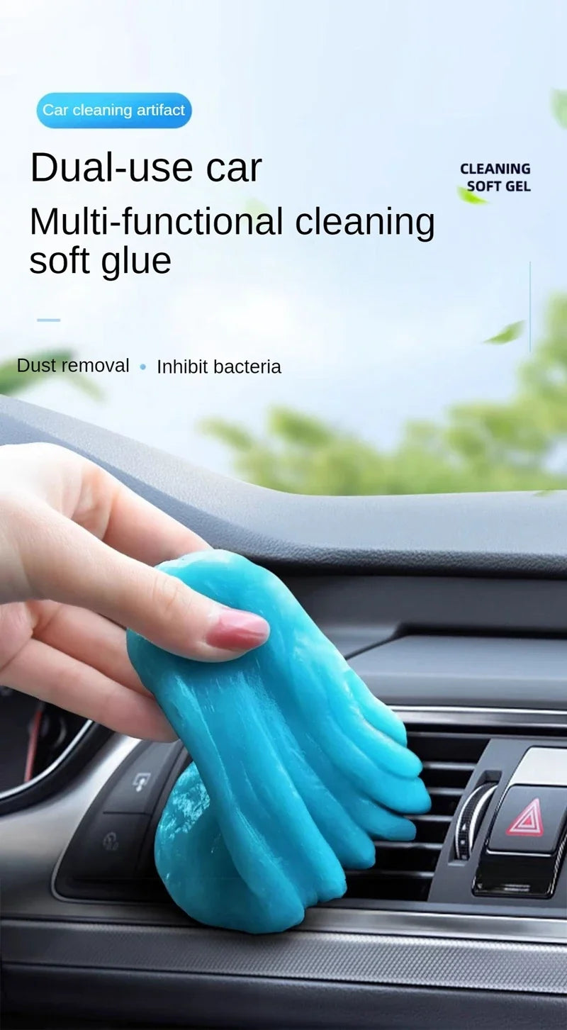 A hand is squeezing a bright blue multi-functional cleaning soft glue gel for car cleaning.
