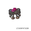 A pink embroidered letter patch featuring a straw hat design.