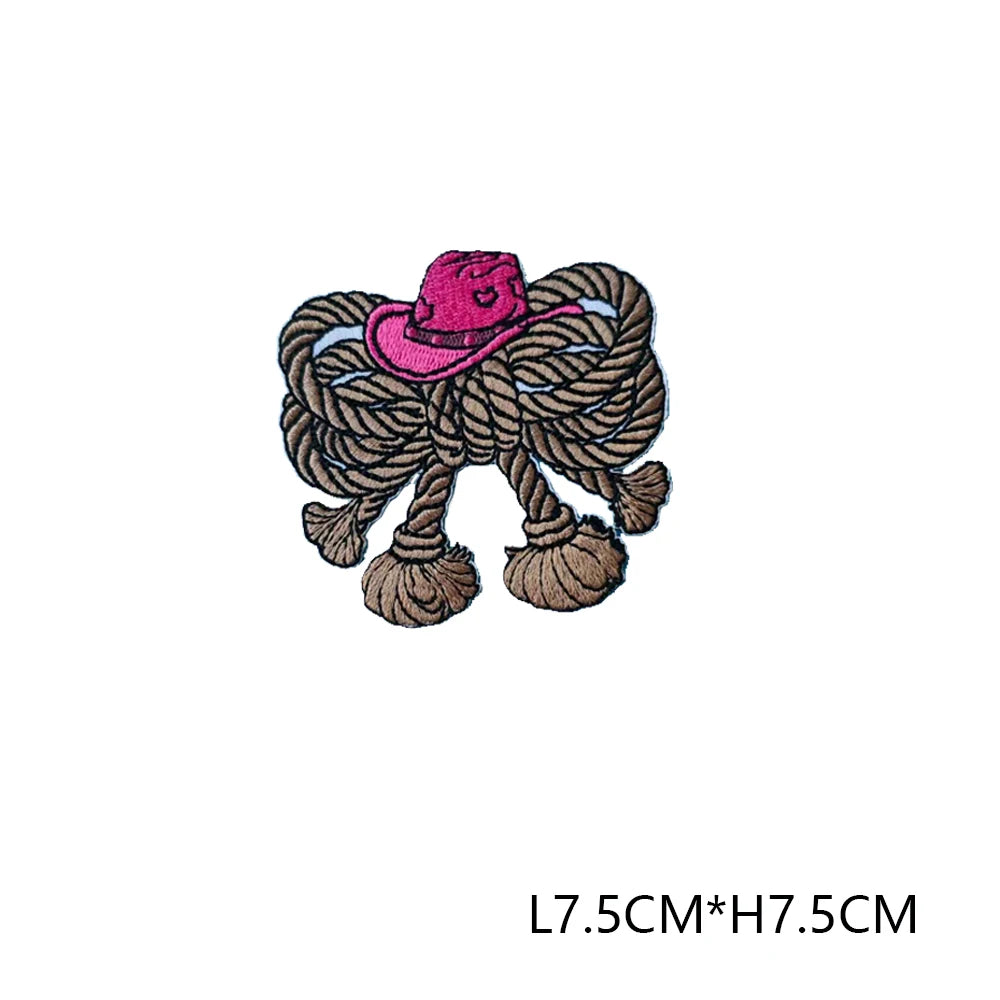 A pink embroidered letter patch featuring a straw hat design.
