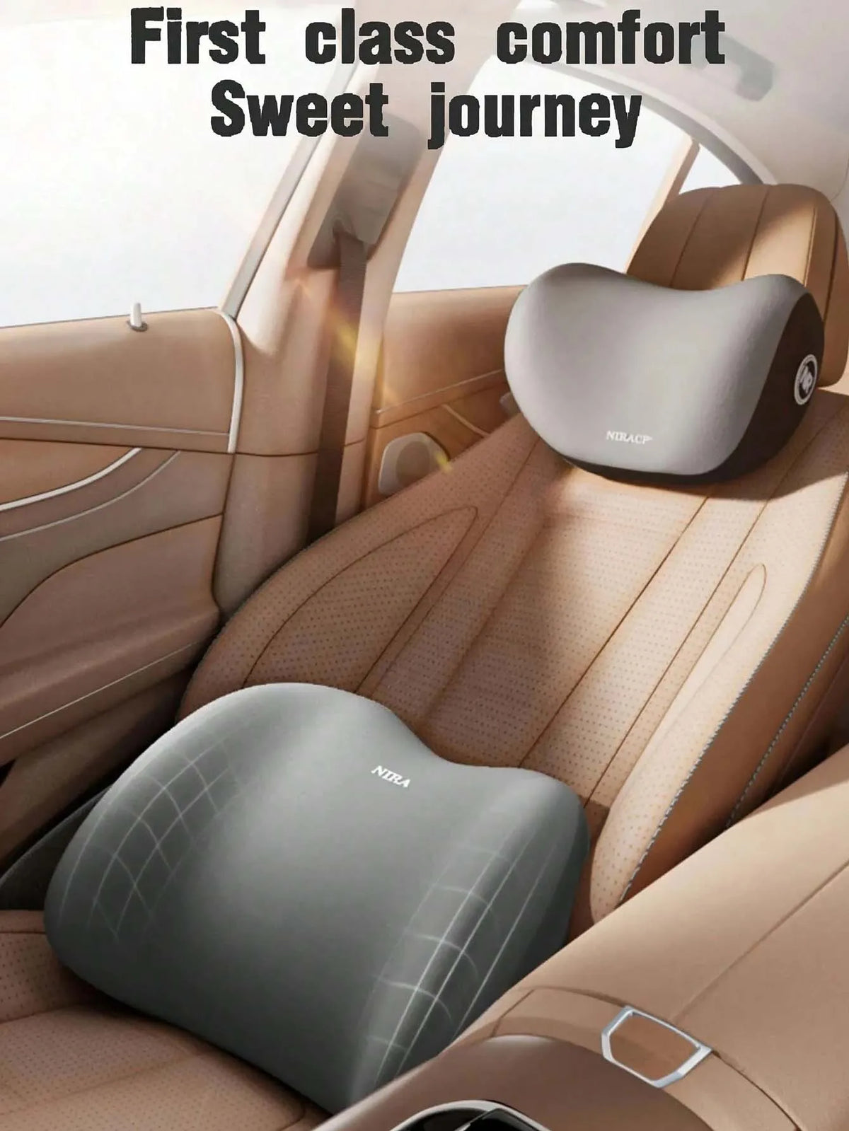 Interior view of a car seat showing first class comfort headrest and lumbar support pillows in beige leather.