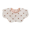 A light beige muslin cotton baby bib with a snap closure and small brown heart embroidery.