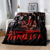 A dark flannel throw blanket featuring a red and black graphic of Michael Jackson's thriller title.