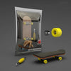 A wooden finger skateboard is shown inside its clear plastic packaging with a yellow grip tape and wheels displayed separatel