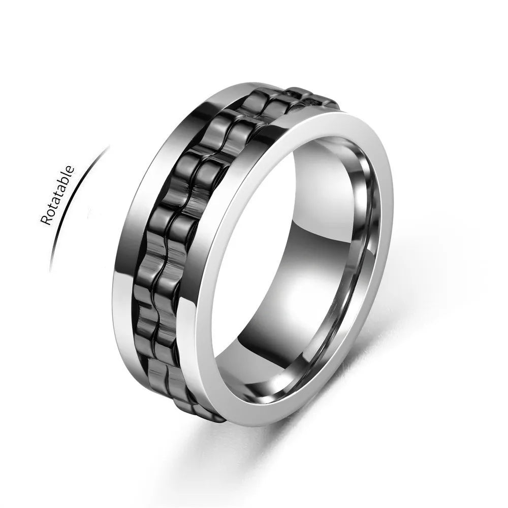 A silver ring with a black gear chain design, shown rotating on a white background.
