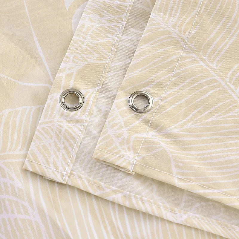 Close-up of a beige fabric shower curtain featuring a white striped pattern and silver grommets.