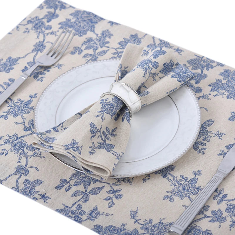A beige gingham table runner with a white plate and silverware displayed on it.