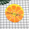 A bright orange citrus fruit design on a yellow background used as a waterproof shower cap.